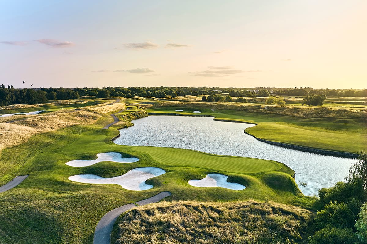 A golden-hour aerial of a bunkered, water-lined green on L'Albatros at Le Golf National, host of the 2018 Ryder Cup.