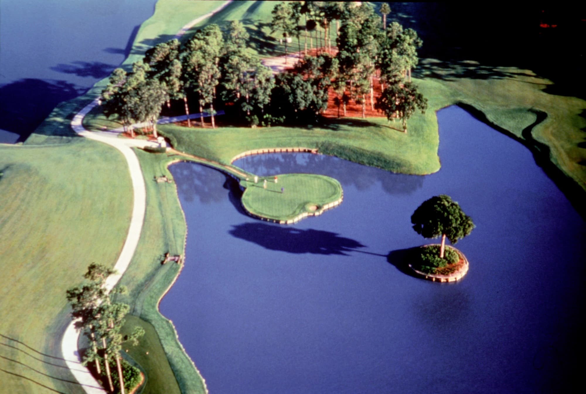 Aerial of the island-green 17th hole at TPC Sawgrass, surrounded by water, Florida.