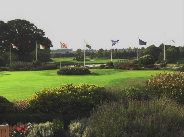 Flags flying over the putting green looking out to the Brabazon Course at The Belfry, host of four Ryder Cups.