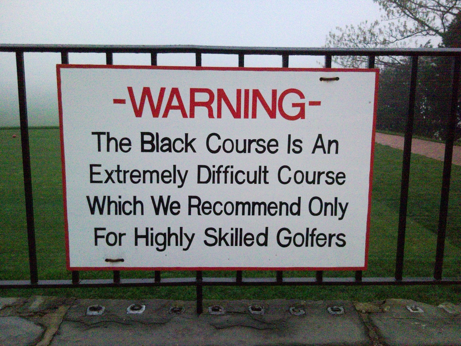 The famous warning sign at the first tee of the Black Course at Bethpage State Park, New York.
