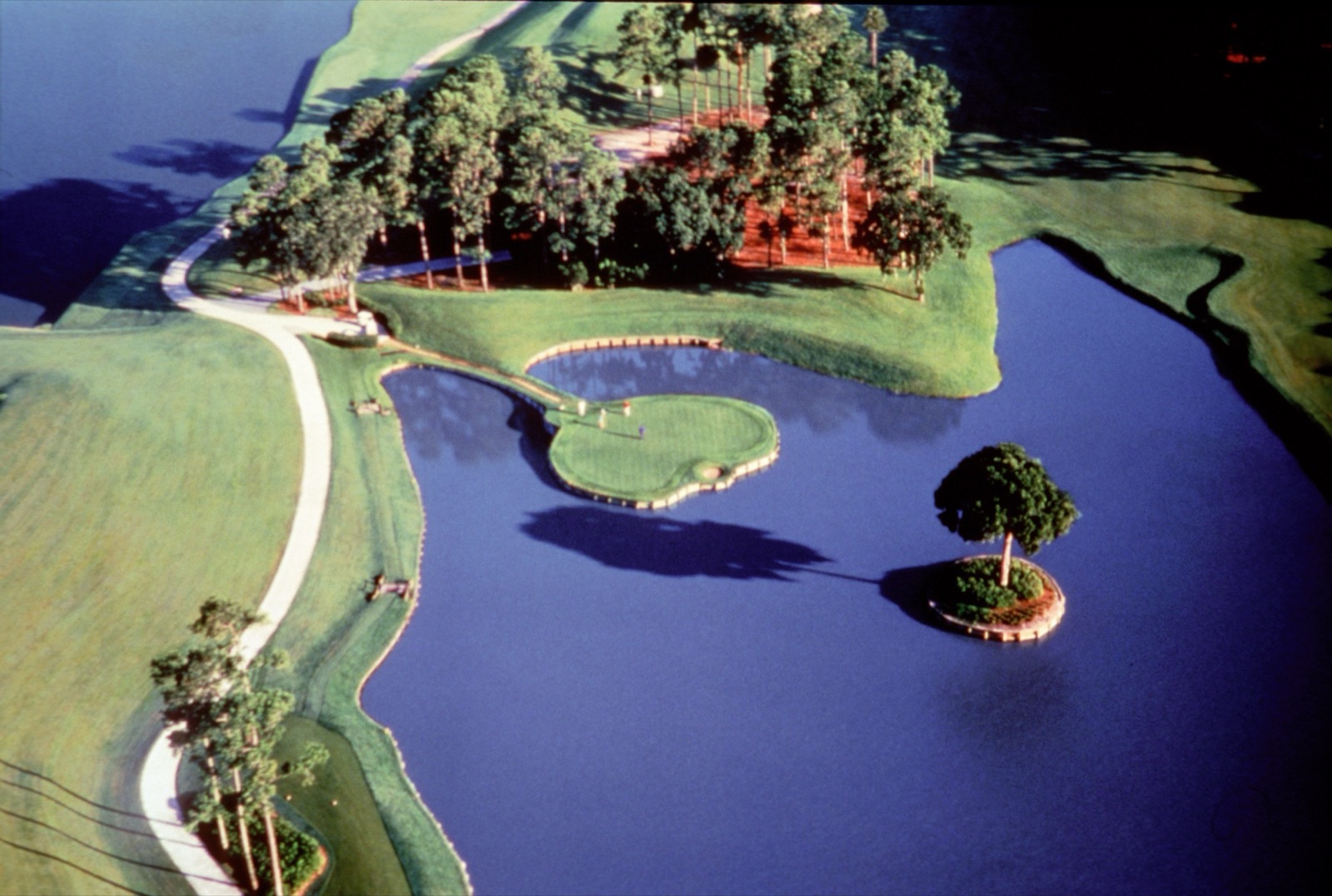 Aerial of the island-green 17th hole at TPC Sawgrass, surrounded by water, Florida.