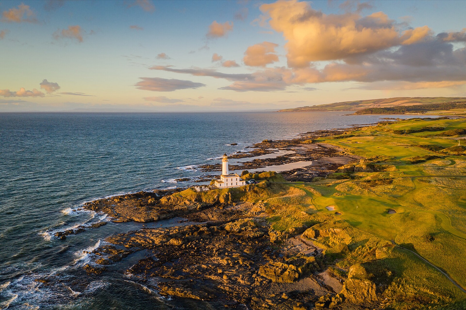 The Turnberry lighthouse at sunset, surrounded by the Ailsa golf course, Ayrshire.