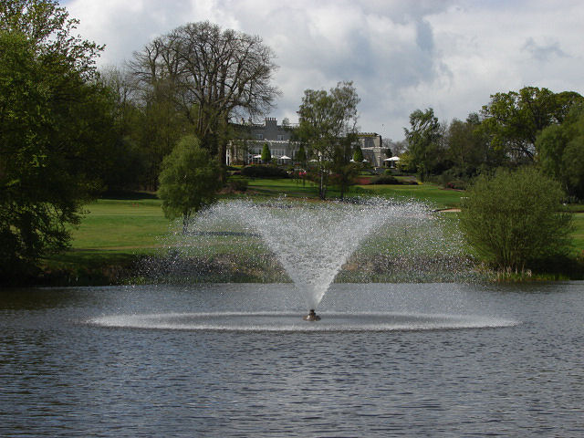 The Wentworth clubhouse and grounds behind the fountain lake at Virginia Water, Surrey.